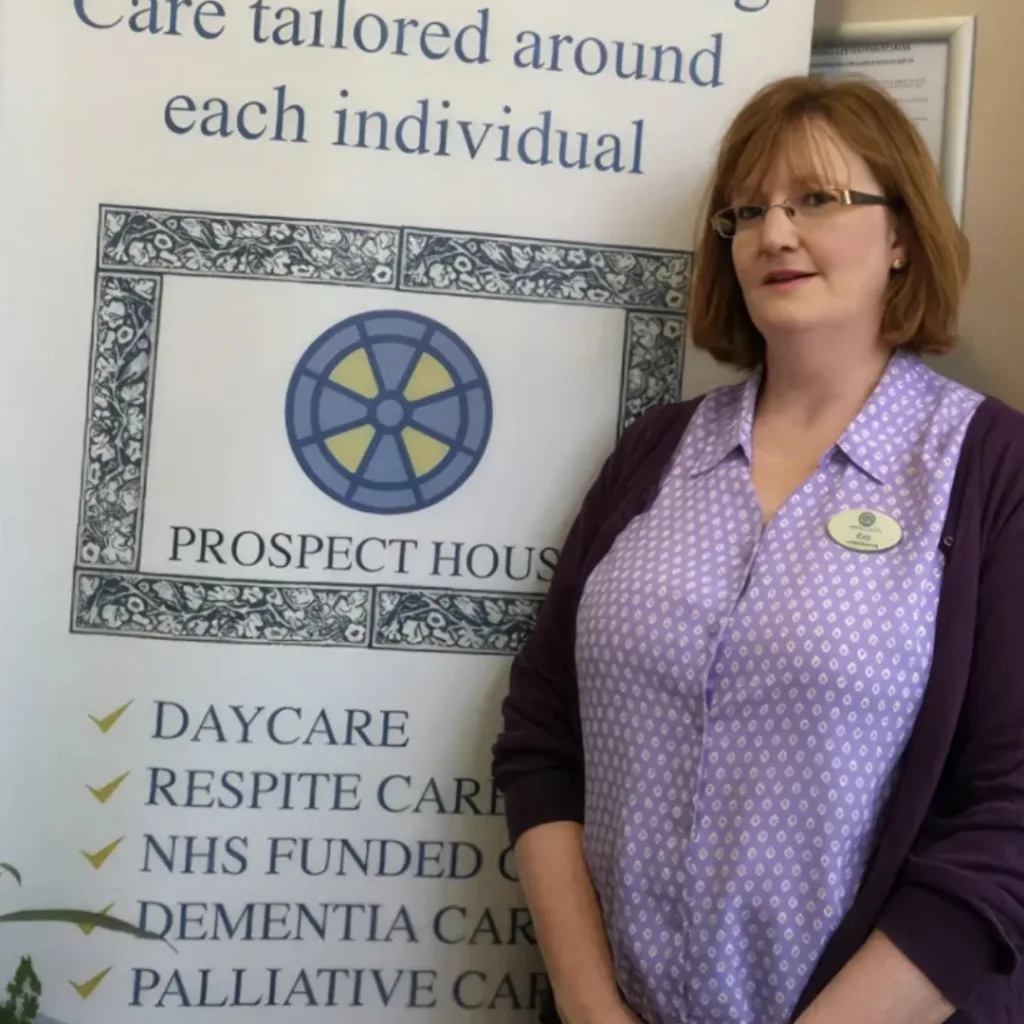 office manager standing in front of sign